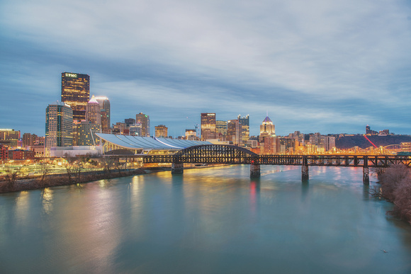 Pittsburgh skyline in the morning over a smooth Allegheny River